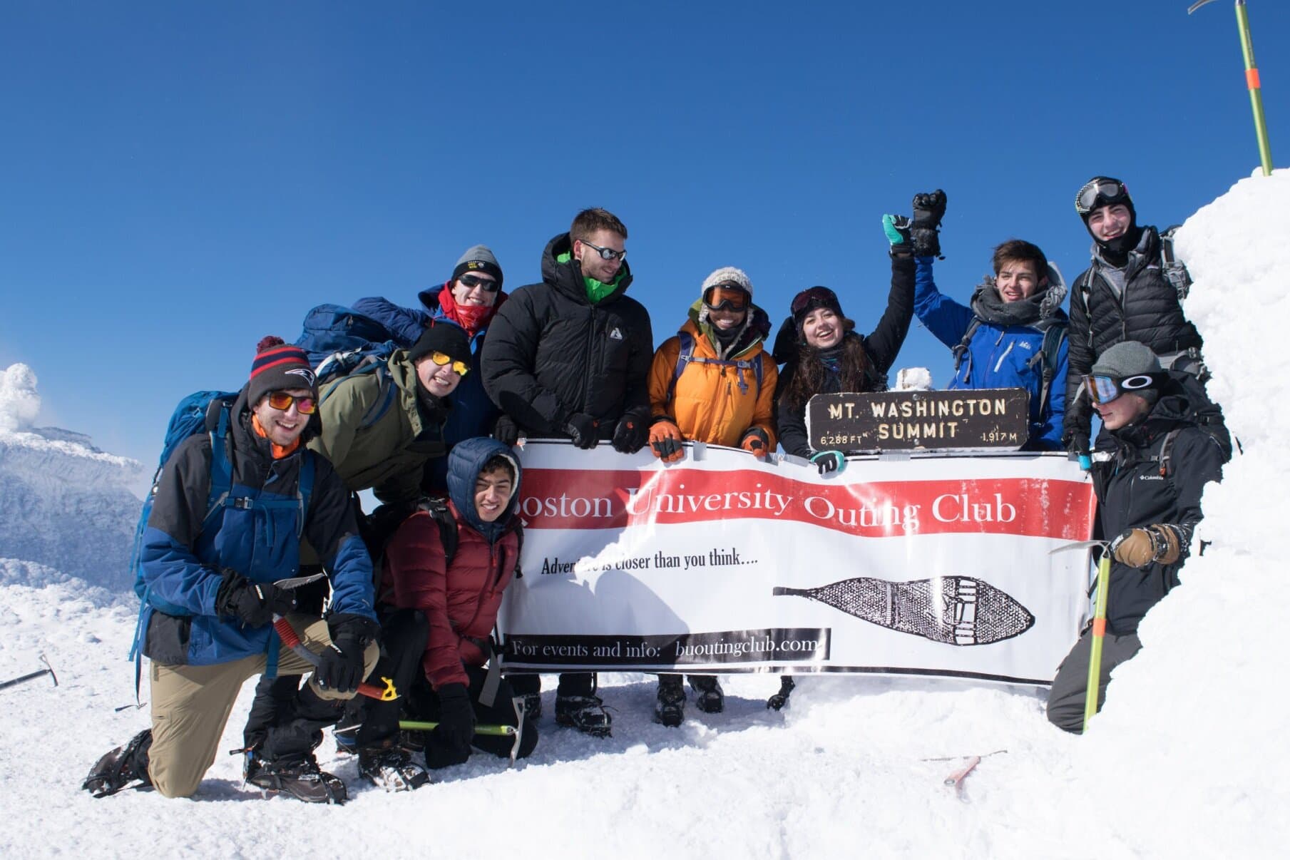 Members holding a banner in the snow